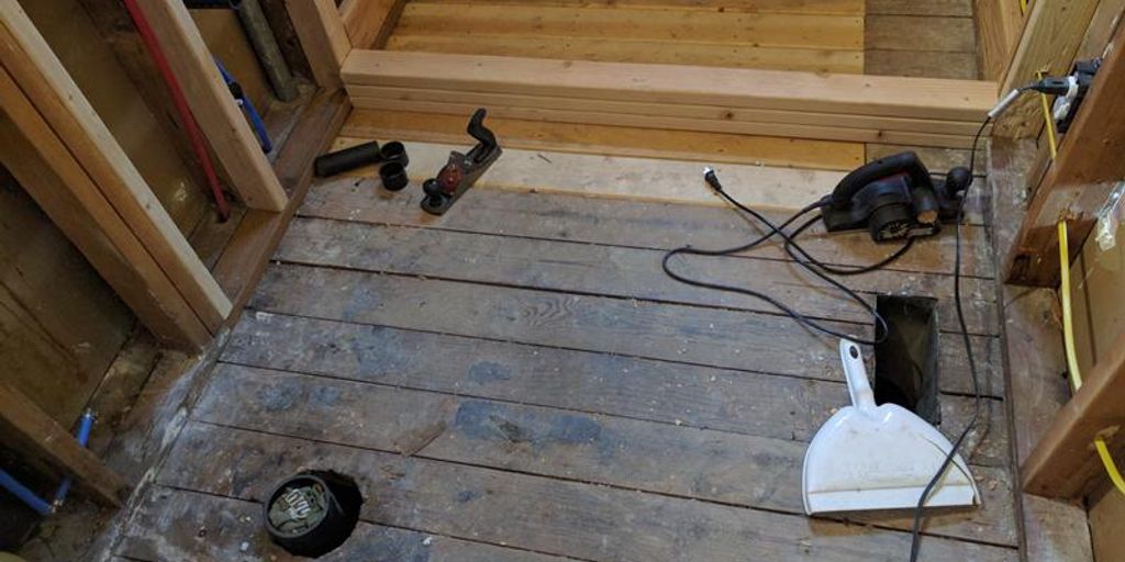 person laying tiles in a home improvement project